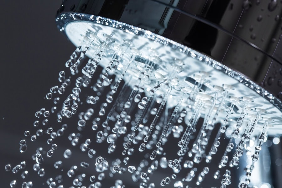 Shower head with hot water running.